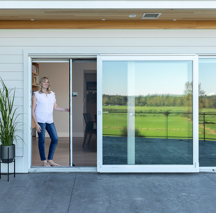 Boy using retractable screen on patio door