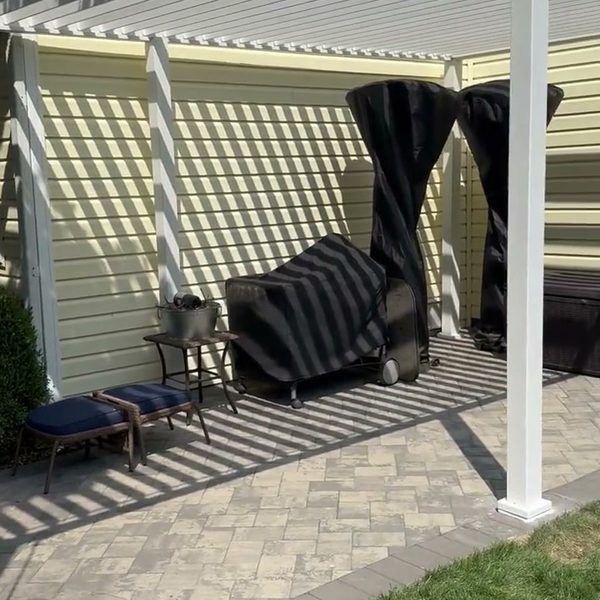 White louvered pergola on a paver patio
