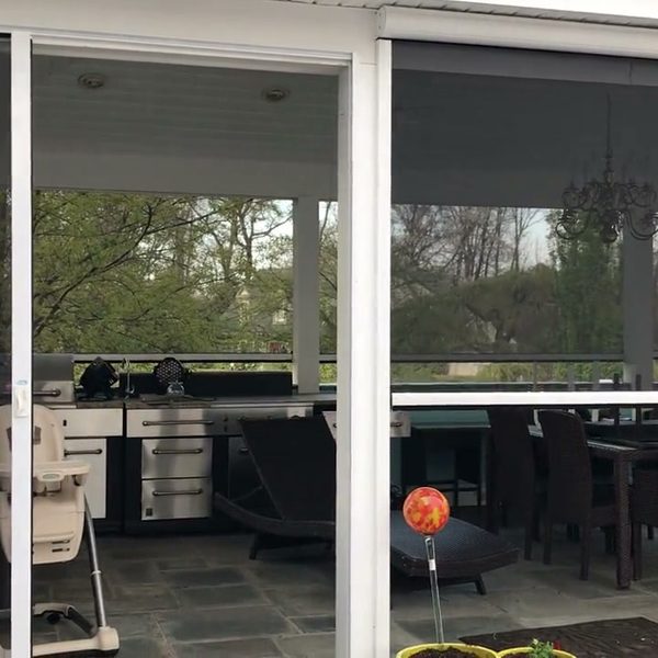 Motorized screens on a backyard pavilion