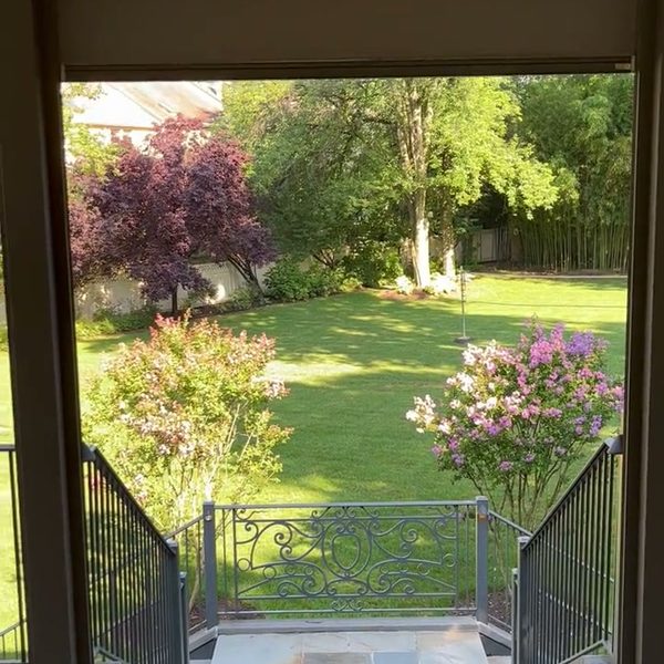 Motorized screens on a stone porch