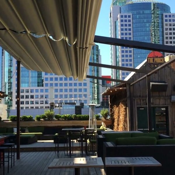 A retractable roof over a city rooftop bar